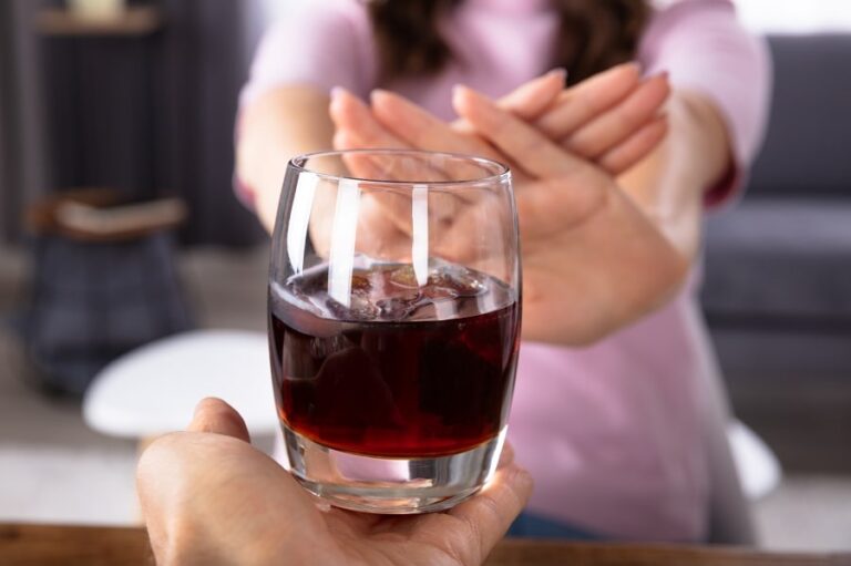 Woman refusing a drink after quitting alcohol
